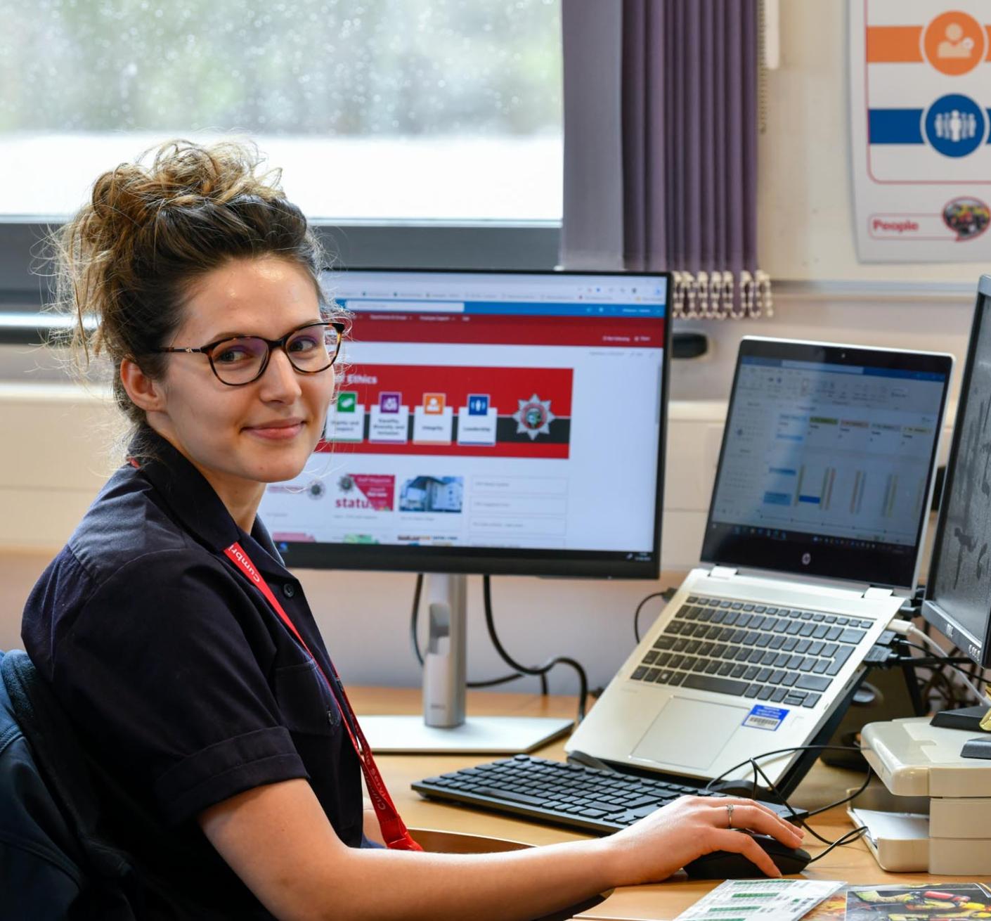 CFRS staff smiling at a laptop