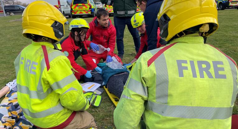 Two firefighters work with partner agencies during a training exercise